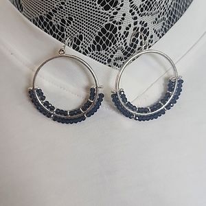 Silver hoop earrings with blue stones